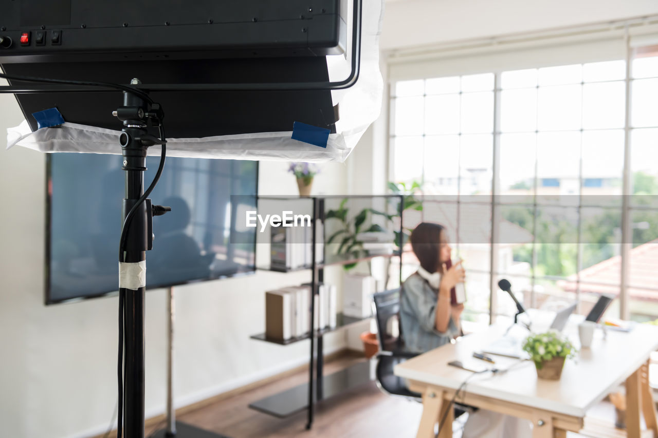 Defocused image of woman blogging at office