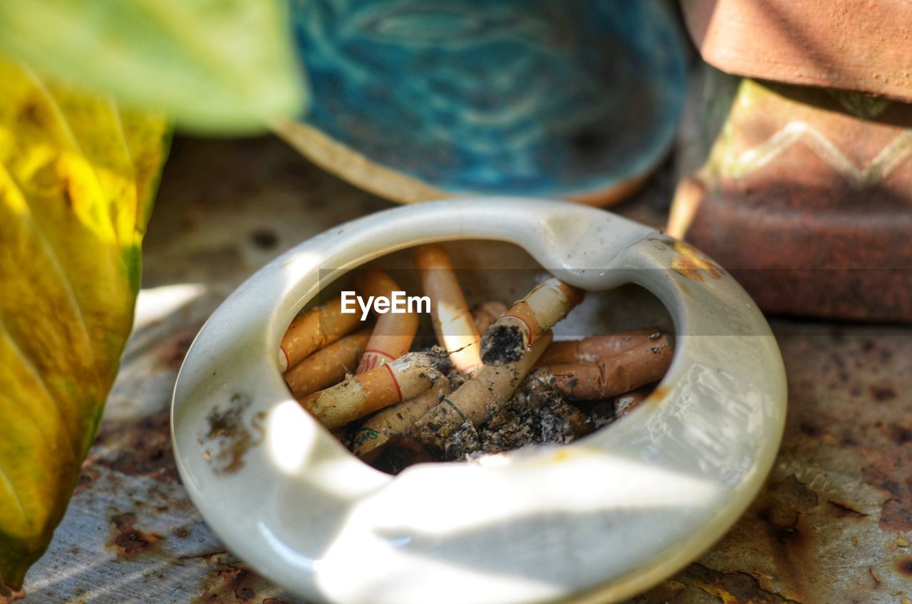 HIGH ANGLE VIEW OF CIGARETTE IN CONTAINER