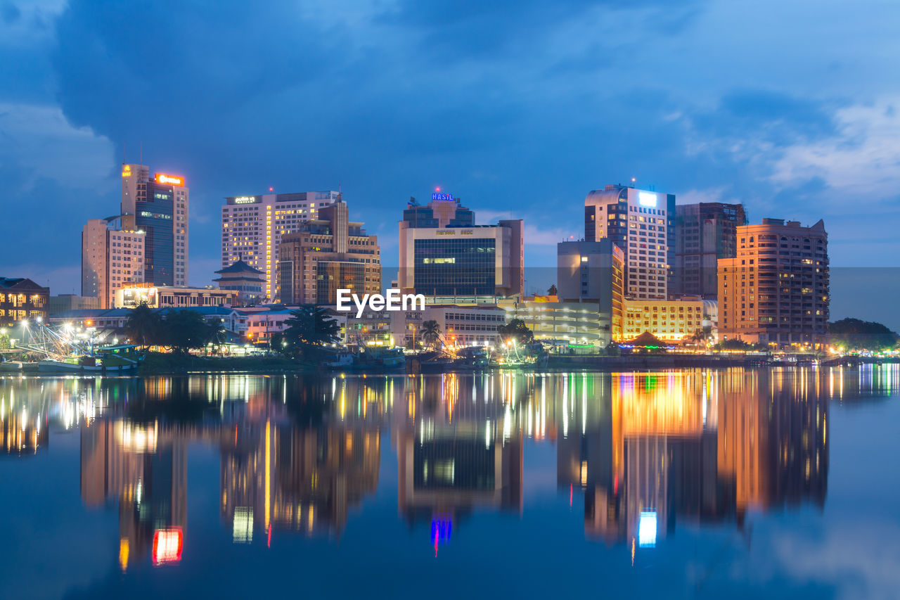 Reflection of illuminated buildings in city at night