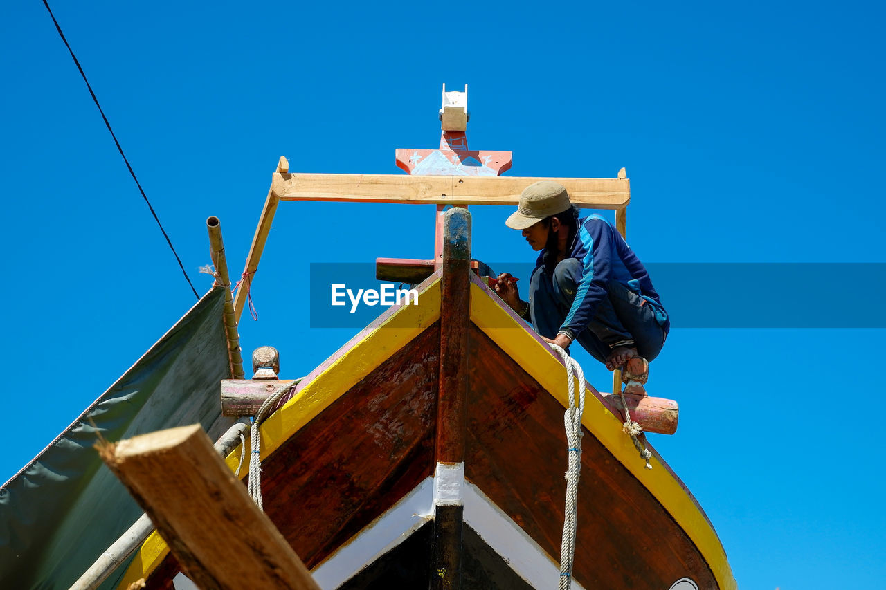 Low angle view of built structure against clear blue sky