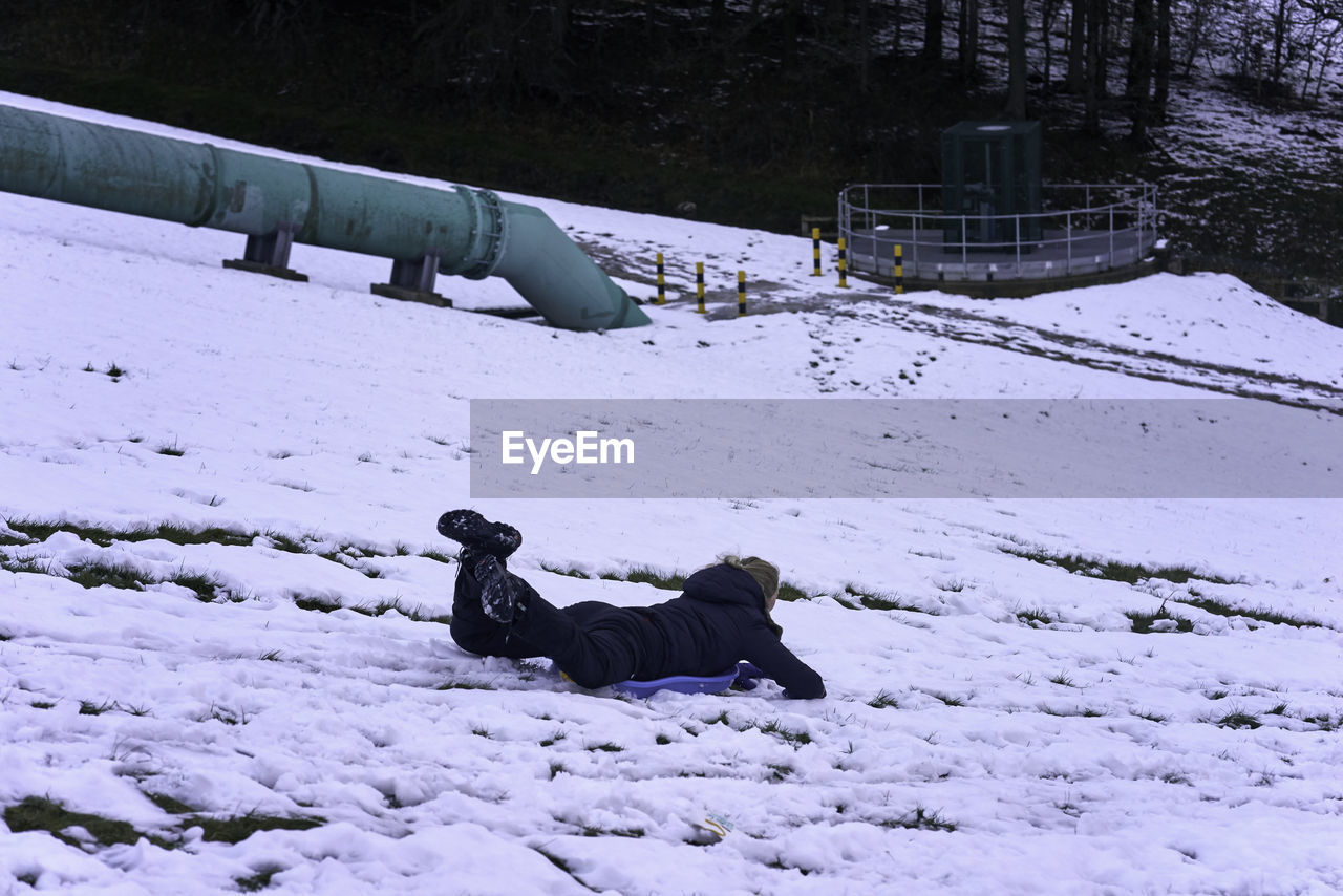 MAN ON SNOW COVERED LAND