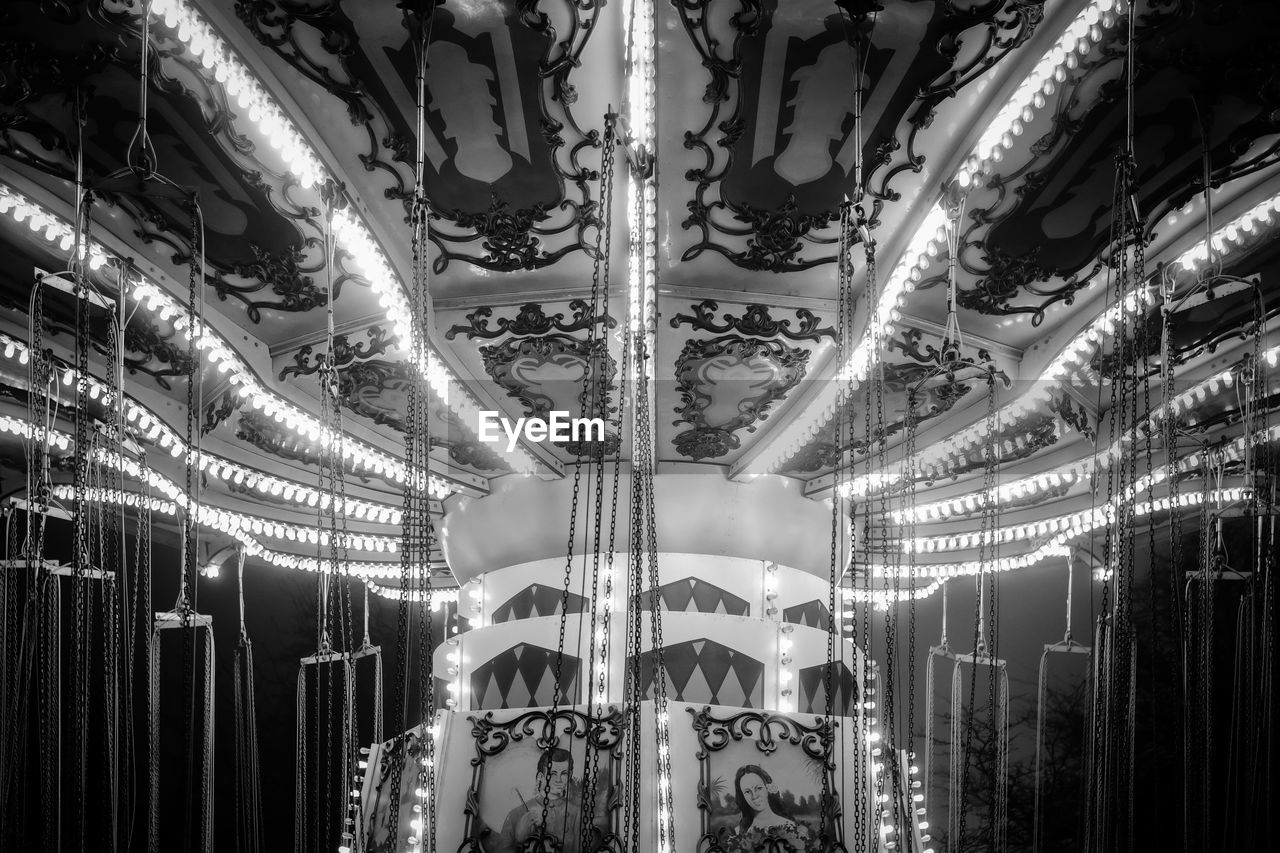 carousel, arts culture and entertainment, amusement park, amusement ride, amusement park ride, black and white, park, illuminated, recreation, carousel horses, monochrome, night, no people, lighting equipment, horse, monochrome photography, low angle view, animal representation, leisure activity, enjoyment, fun