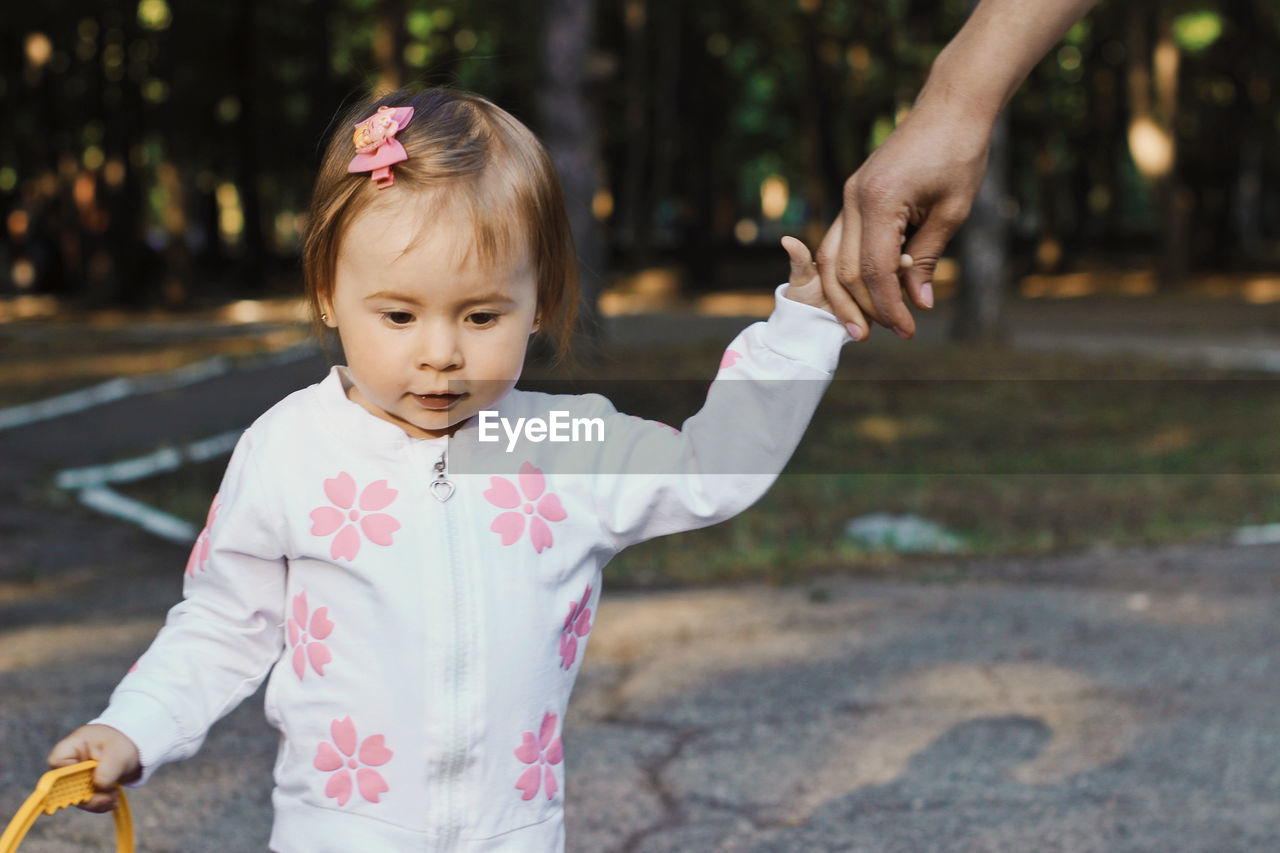 Baby Babygirl Babyhood Casual Clothing Child Childhood Cute Day Females Focus On Foreground Front View Girl Girls Human Arm Innocence Leisure Activity Lifestyles One Person Outdoors Portrait Preschool Age Real People Standing Summer Women