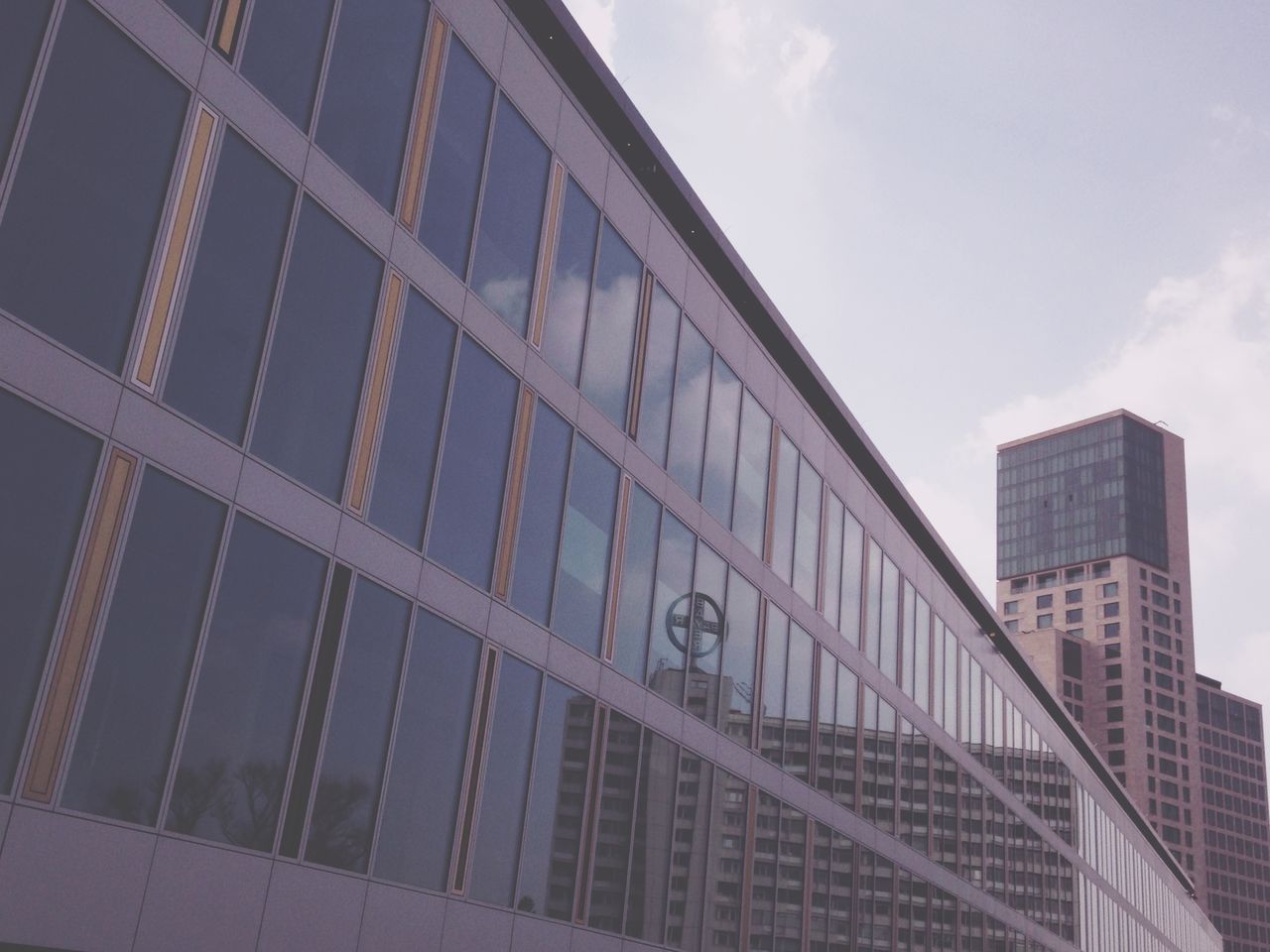 LOW ANGLE VIEW OF MODERN BUILDINGS AGAINST SKY