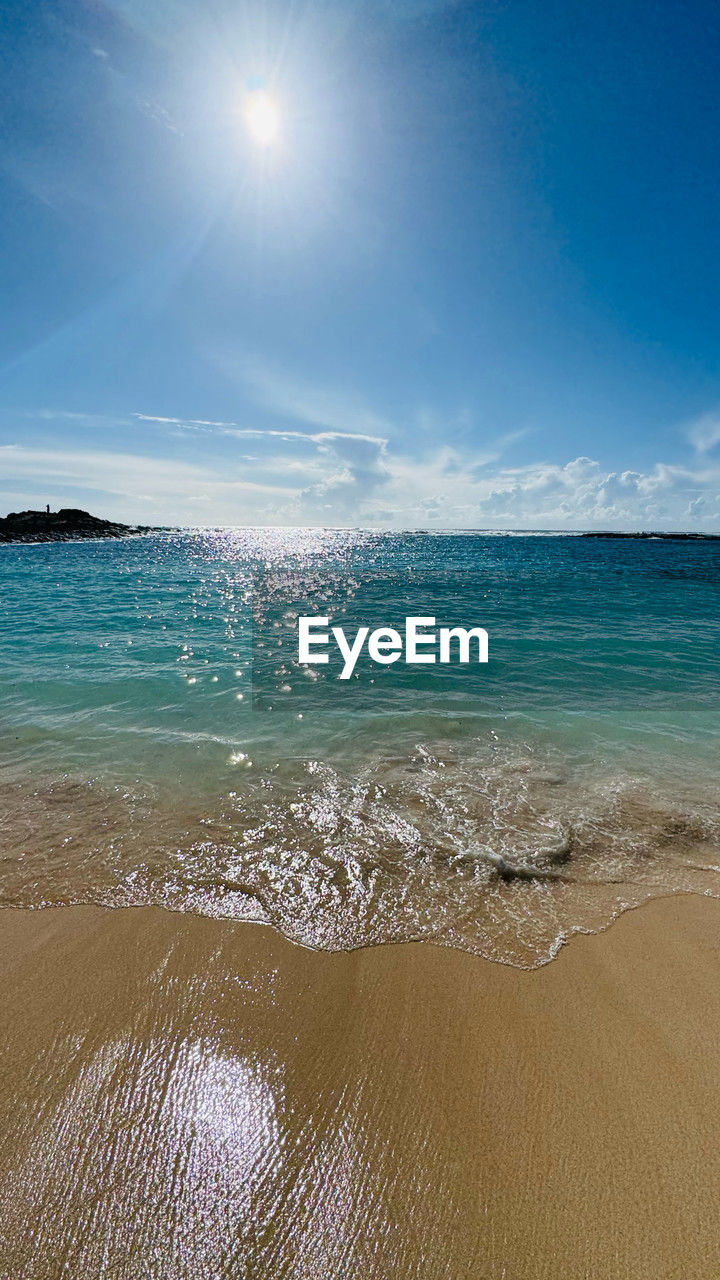sea, water, land, sky, beach, wind wave, horizon, body of water, wave, beauty in nature, ocean, scenics - nature, nature, sunlight, sand, shore, sun, blue, environment, tranquility, travel destinations, travel, motion, horizon over water, landscape, sunny, coast, cloud, trip, vacation, holiday, water sports, sports, tranquil scene, summer, outdoors, no people, seascape, tourism, idyllic, coastline, tropical climate, water's edge, day, clear sky, lagoon, island