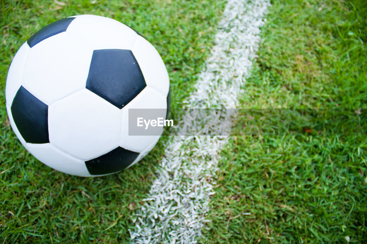 CLOSE-UP OF SOCCER BALL ON FIELD