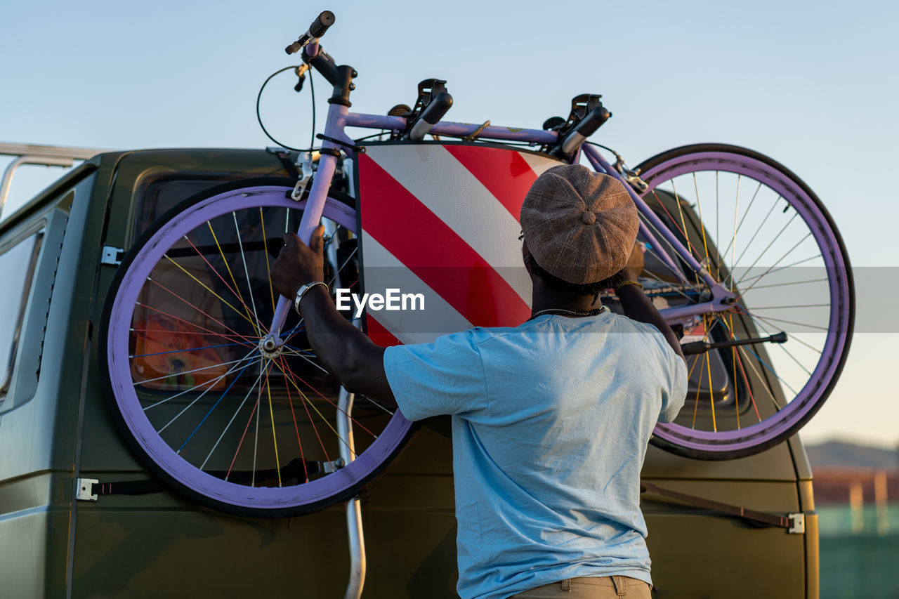 African american man with an old-fashioned bicycle in his van