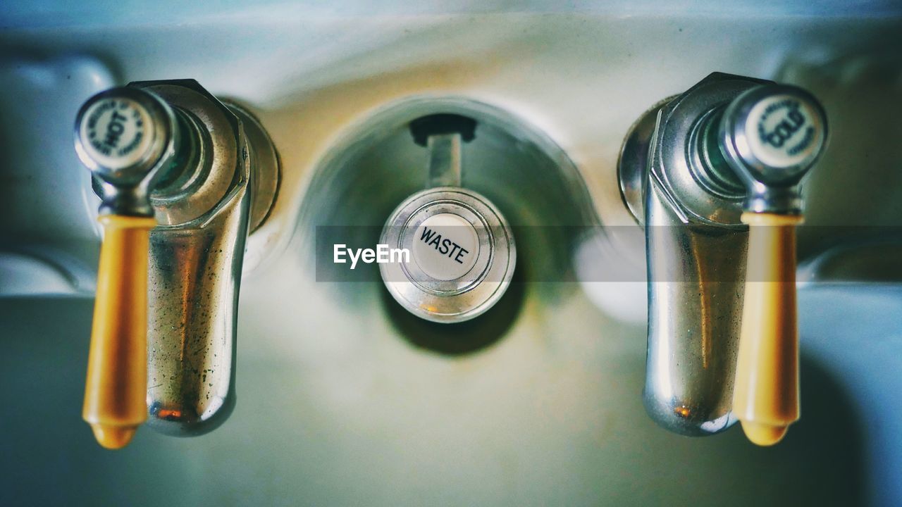 Directly above view of taps with text on sink