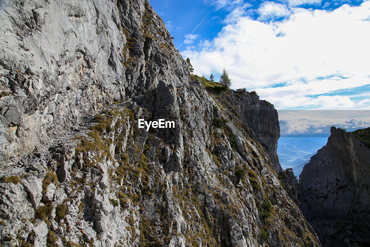 Low angle view of rocky mountains against sky