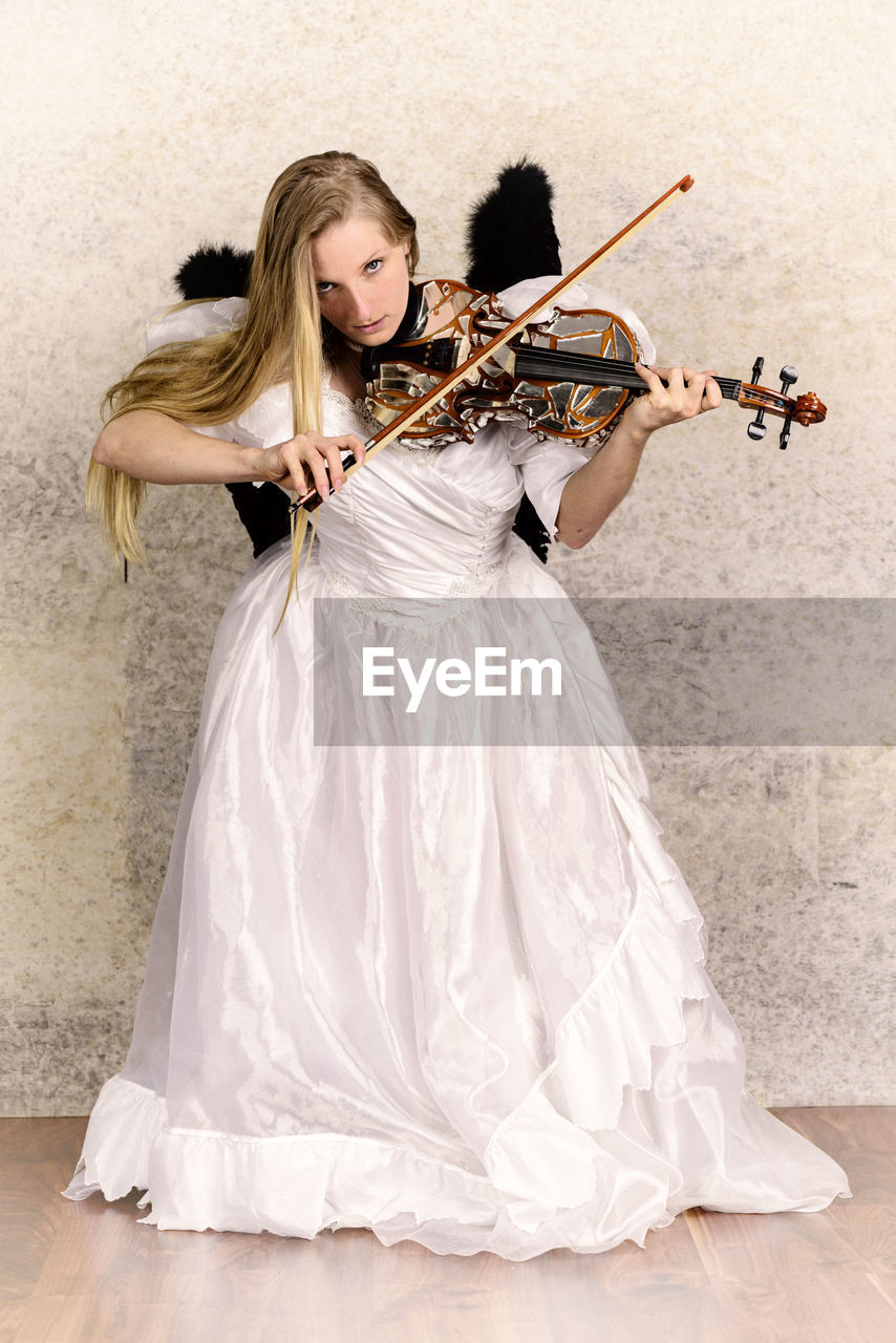 Portrait of woman in costume playing violin