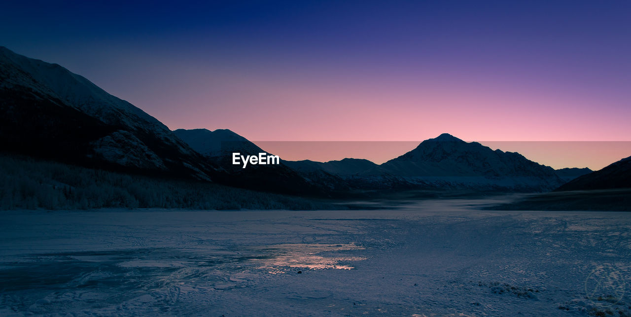 Scenic view of mountains against sky during sunset