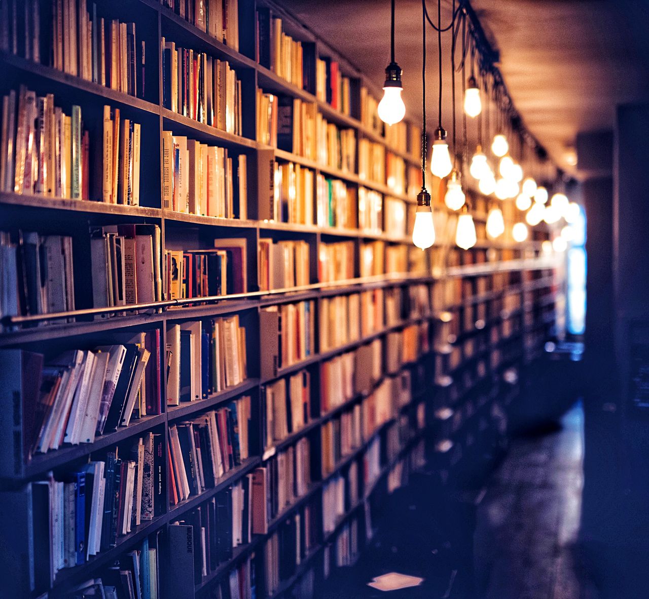 Low angle view of books in illuminated building