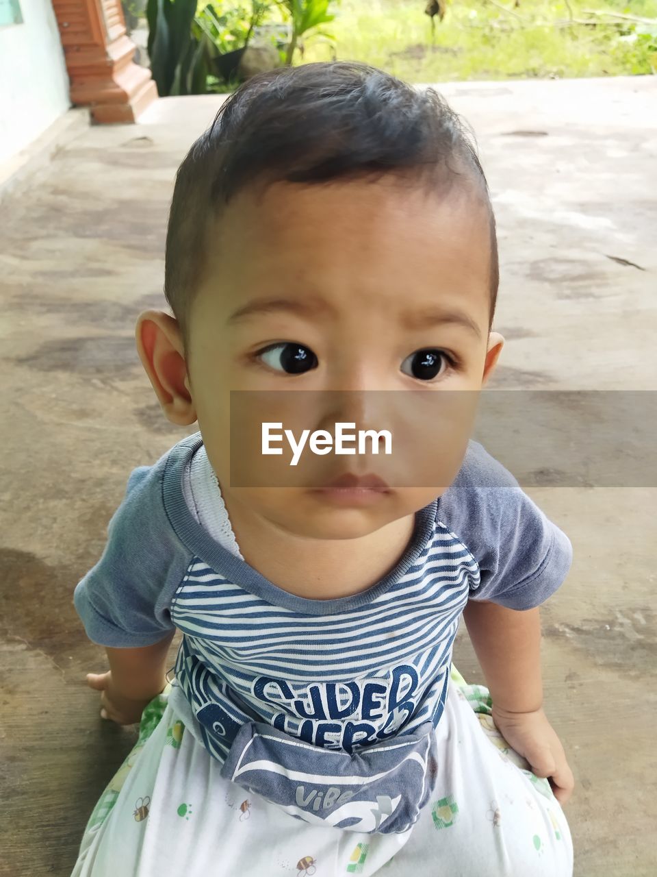 child, childhood, portrait, one person, looking at camera, baby, cute, innocence, front view, person, skin, toddler, day, high angle view, casual clothing, babyhood, emotion, human face, nature, lifestyles, outdoors, smiling, human eye, men, standing, baby clothing, clothing, looking, happiness