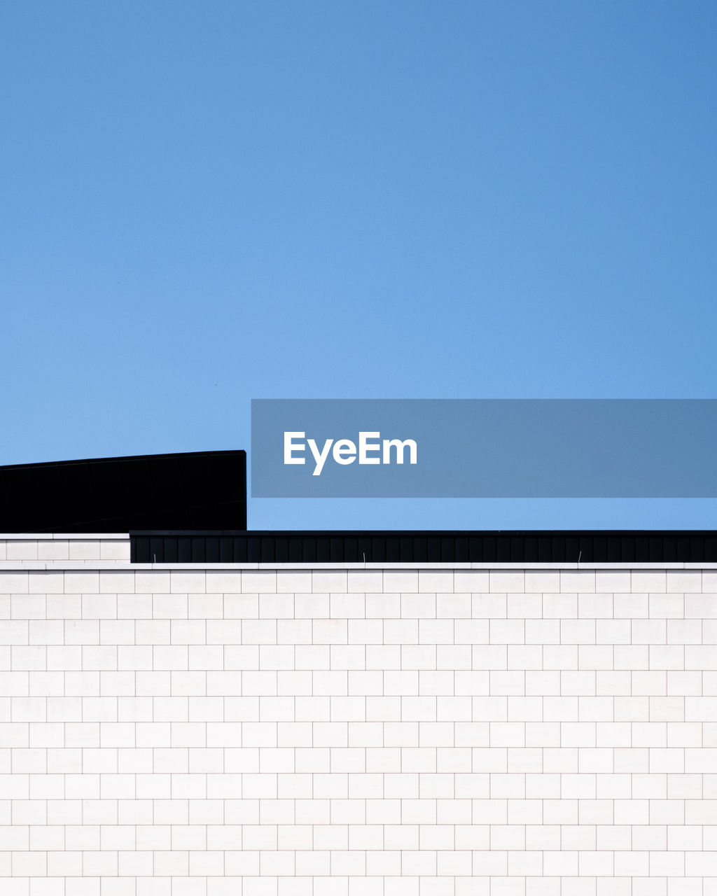 Low angle view of building against clear blue sky