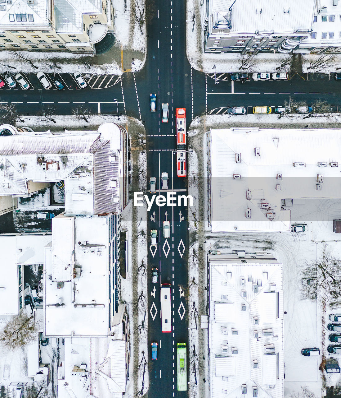 Aerial view of road amidst snow covered buildings in city