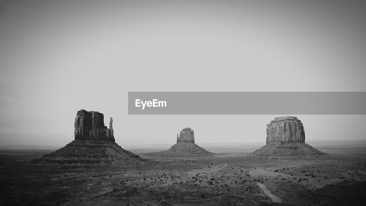 Rock formations on landscape against clear sky