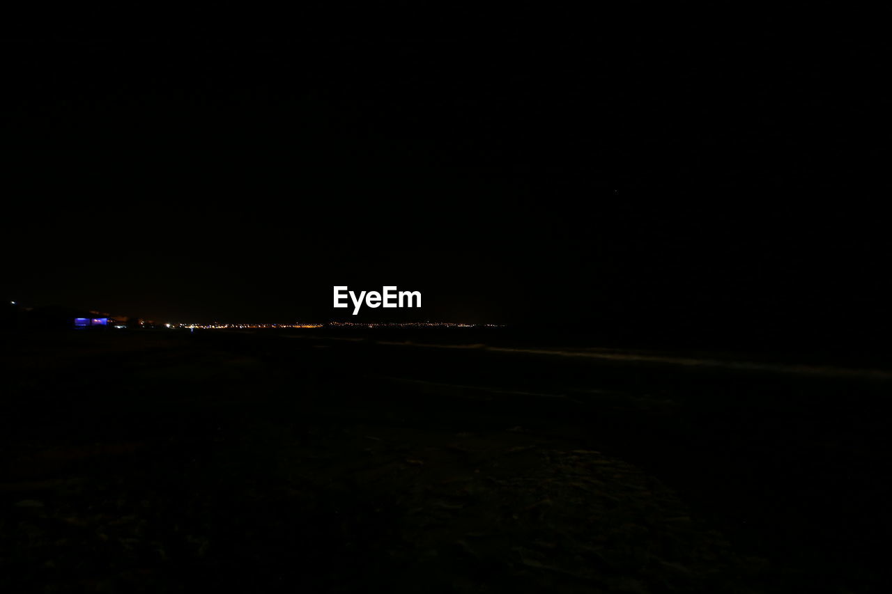 ILLUMINATED BEACH AGAINST CLEAR SKY