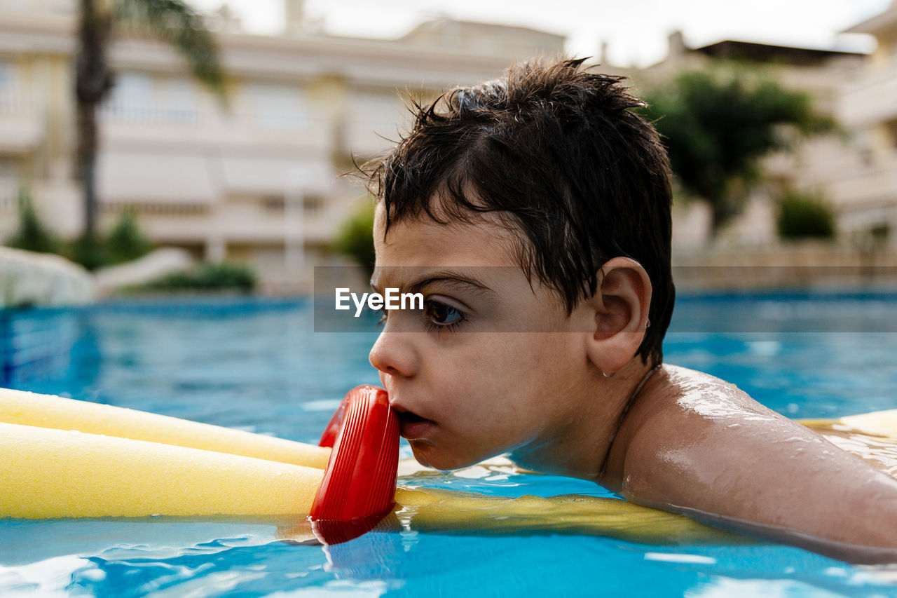 Boy swimming in pool