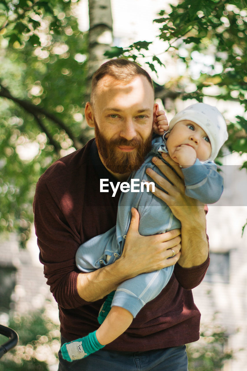 Father with son against trees