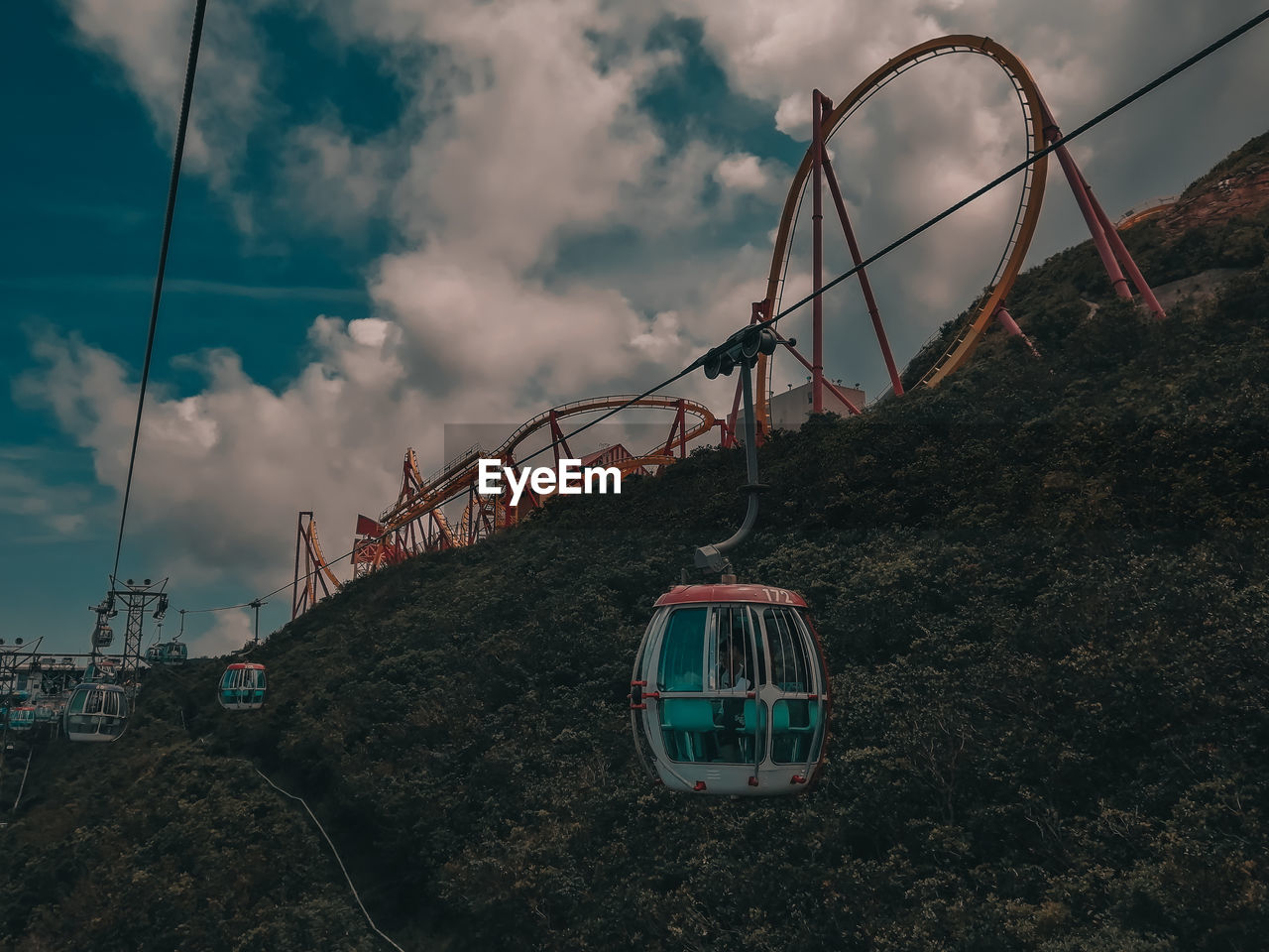 LOW ANGLE VIEW OF OVERHEAD CABLE CAR ON ROCK