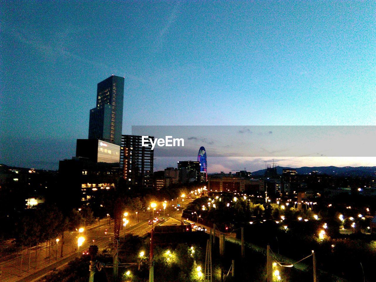 VIEW OF ILLUMINATED CITYSCAPE AT NIGHT