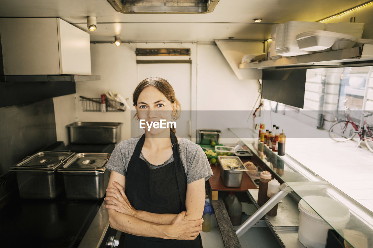 Portrait of confident female chef in food truck