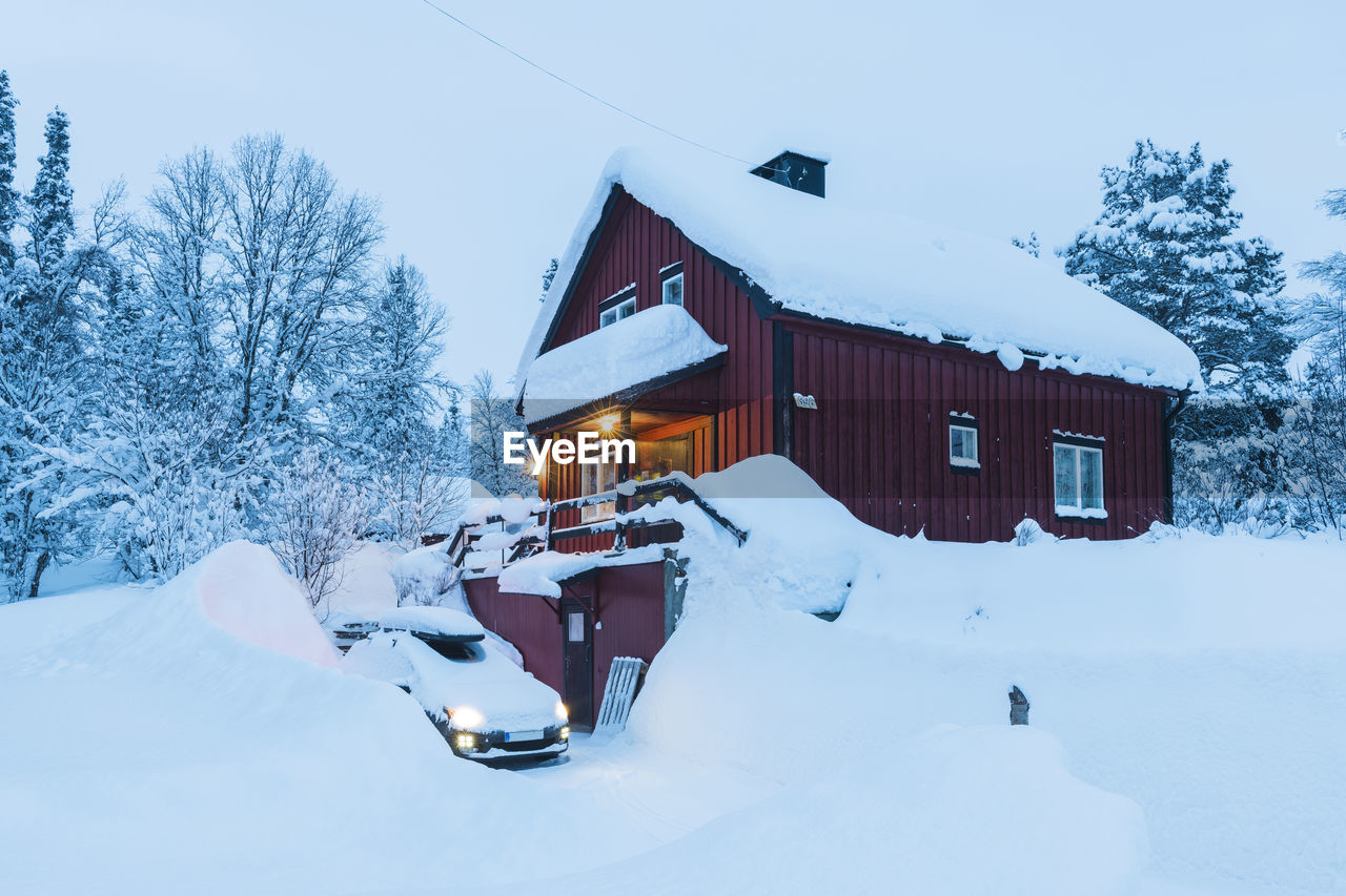 Car in front of snow covered house