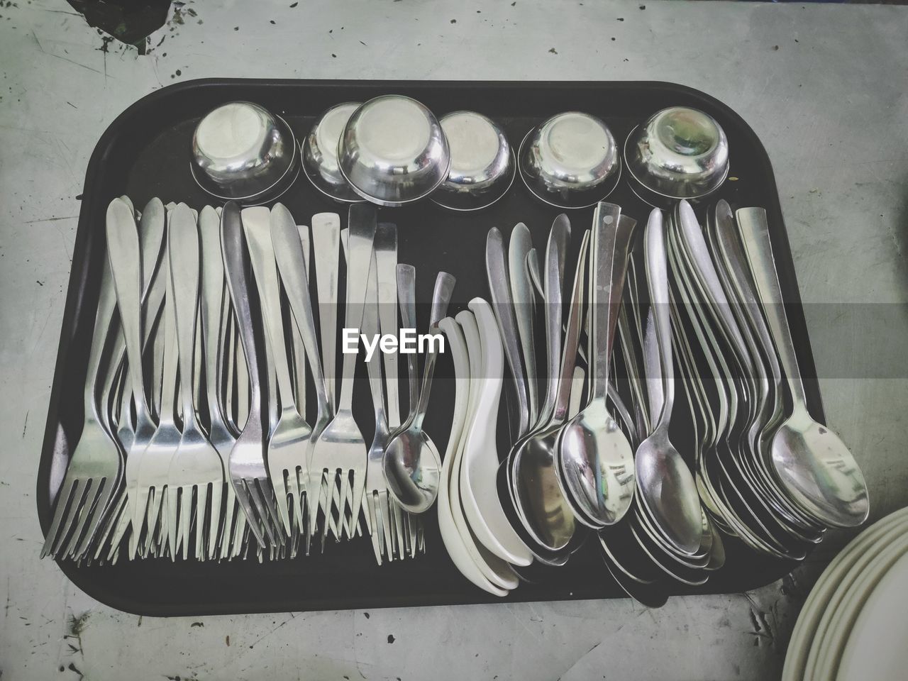 HIGH ANGLE VIEW OF VARIOUS OBJECTS ON METAL IN KITCHEN