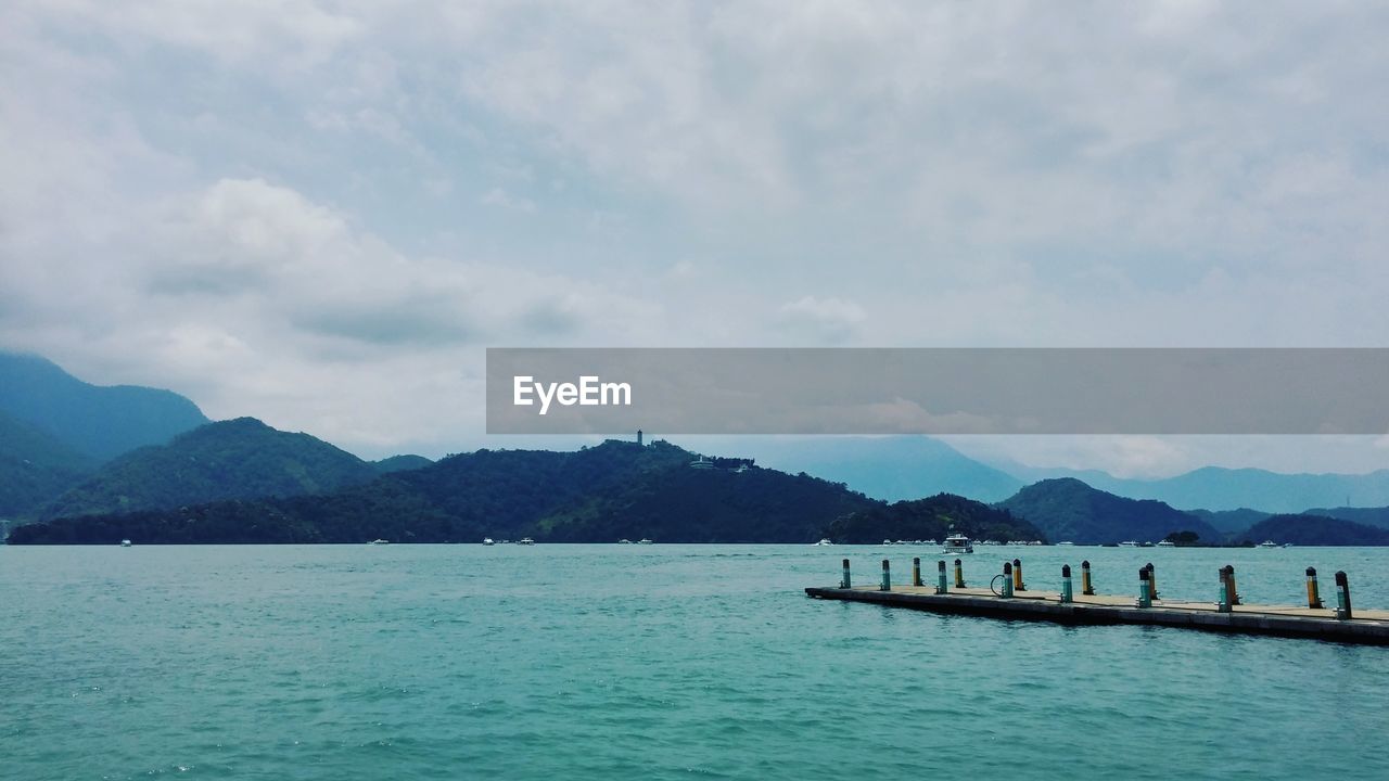 Scenic view of mountains against cloudy sky