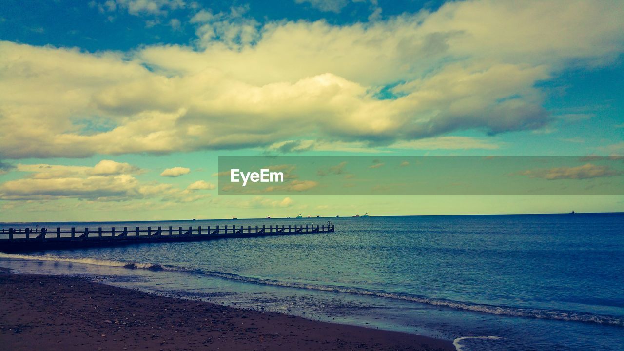 View of calm beach against the sky