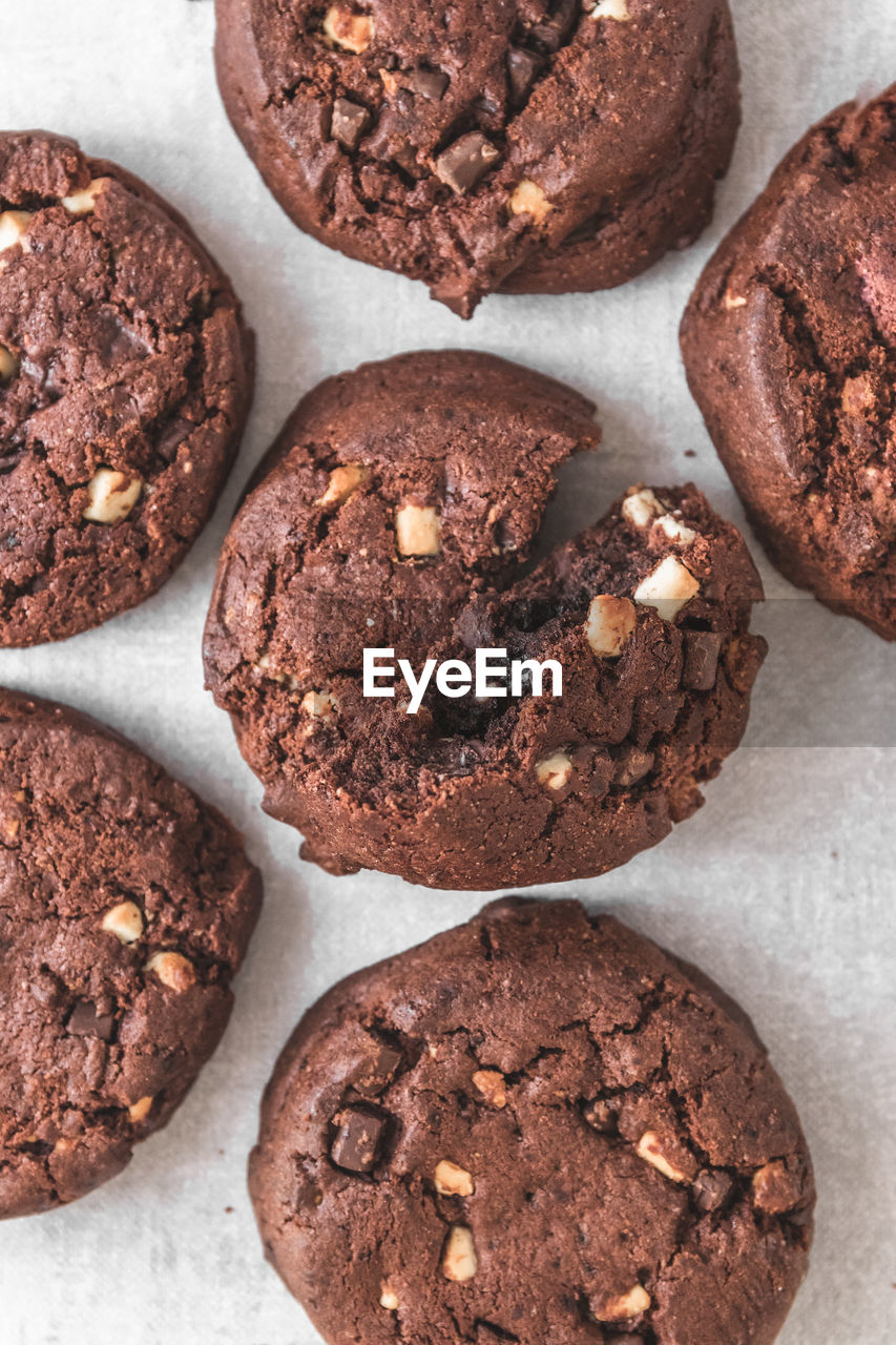 High angle view of chocolate cookies on white plates on table