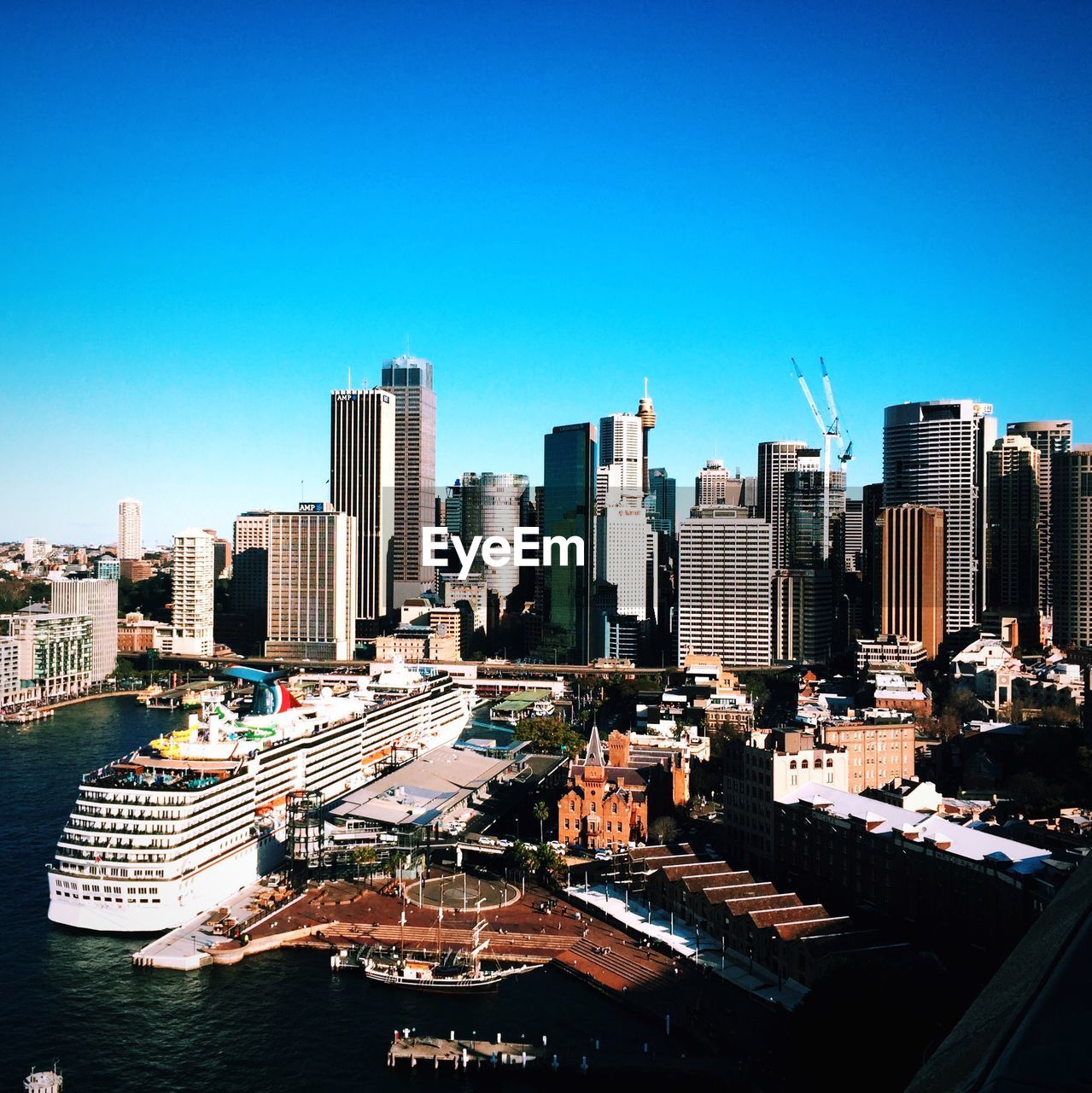 High angle view of cruise ship and cityscape against clear blue sky