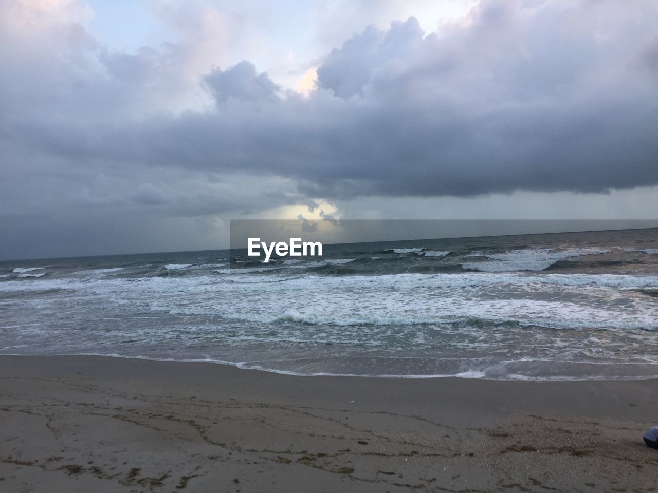 SCENIC VIEW OF SEA AGAINST STORM CLOUDS