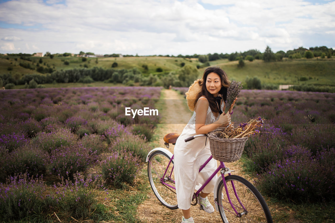 Asian woman with retro bike in lavender field