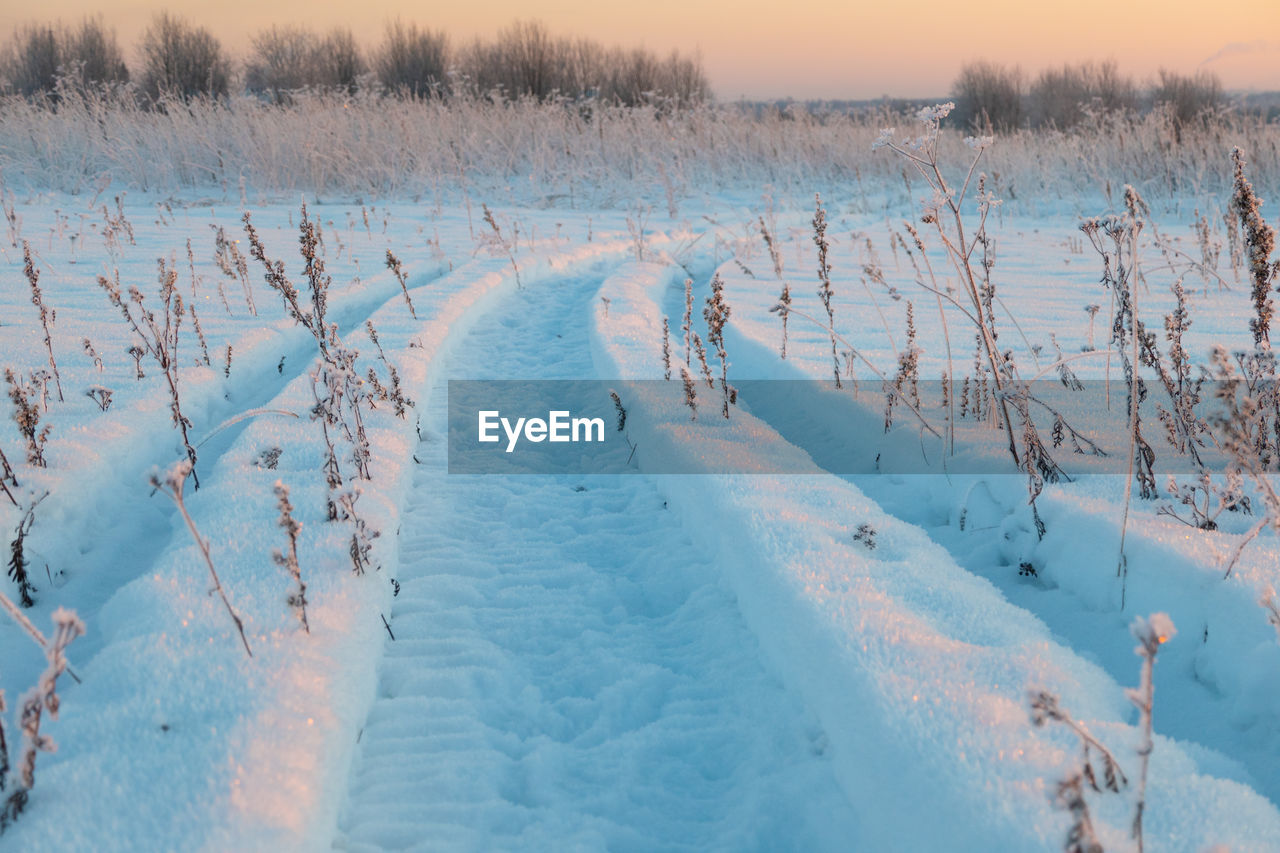 Winter landscape, tire tracks on the snow, snow road