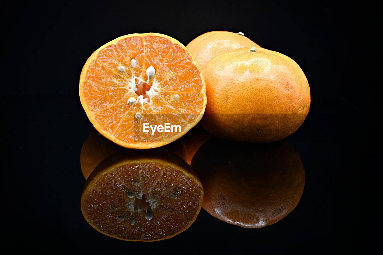 food and drink, fruit, food, healthy eating, plant, wellbeing, black background, citrus fruit, orange color, freshness, produce, studio shot, orange, citrus, indoors, no people, cross section, clementine, yellow, slice, tangerine, still life, close-up, macro photography, juicy, vitamin, antioxidant, halved, cut out, organic, group of objects
