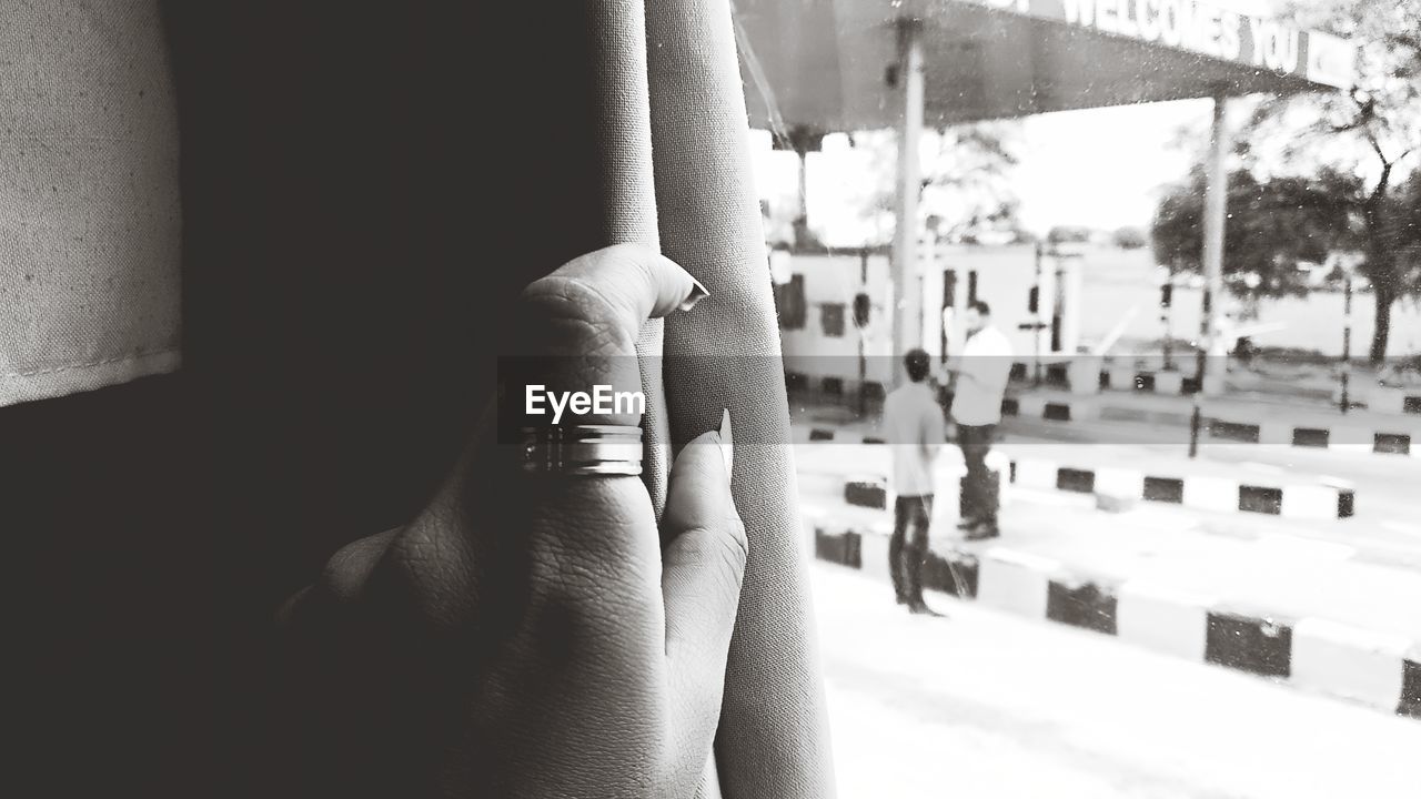 CLOSE-UP OF WOMAN HAND ON WINDOW