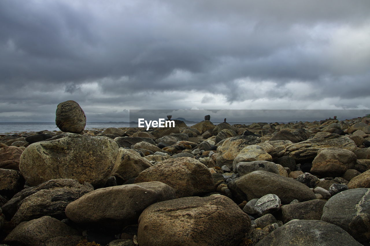 Rocks in sea against sky