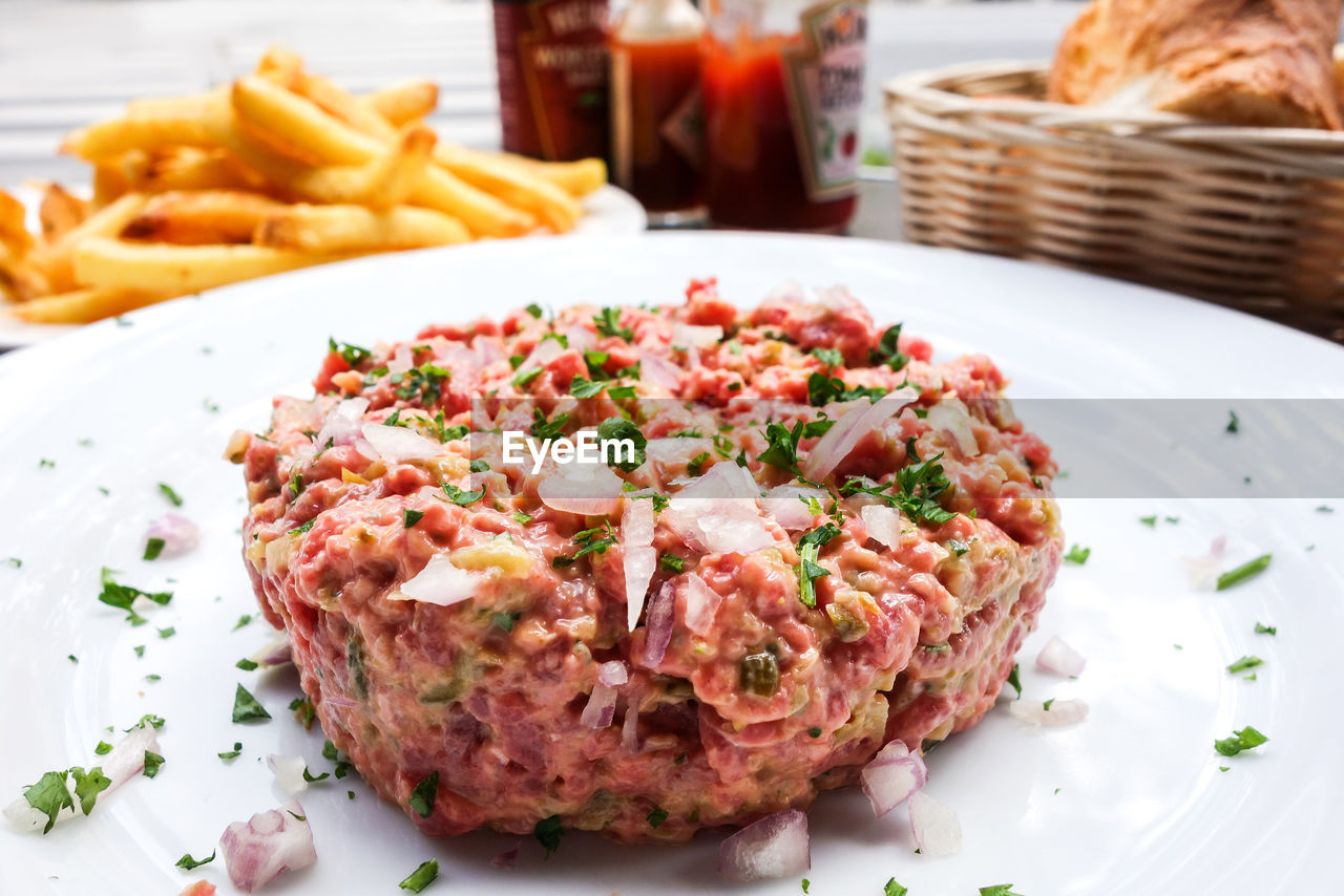 Steamed meatball and fries with hot sauce