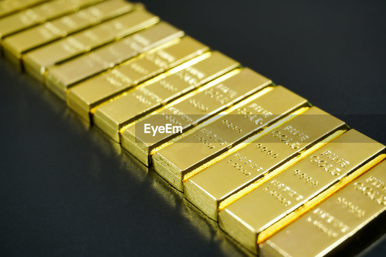 Close-up of gold bars in row on table