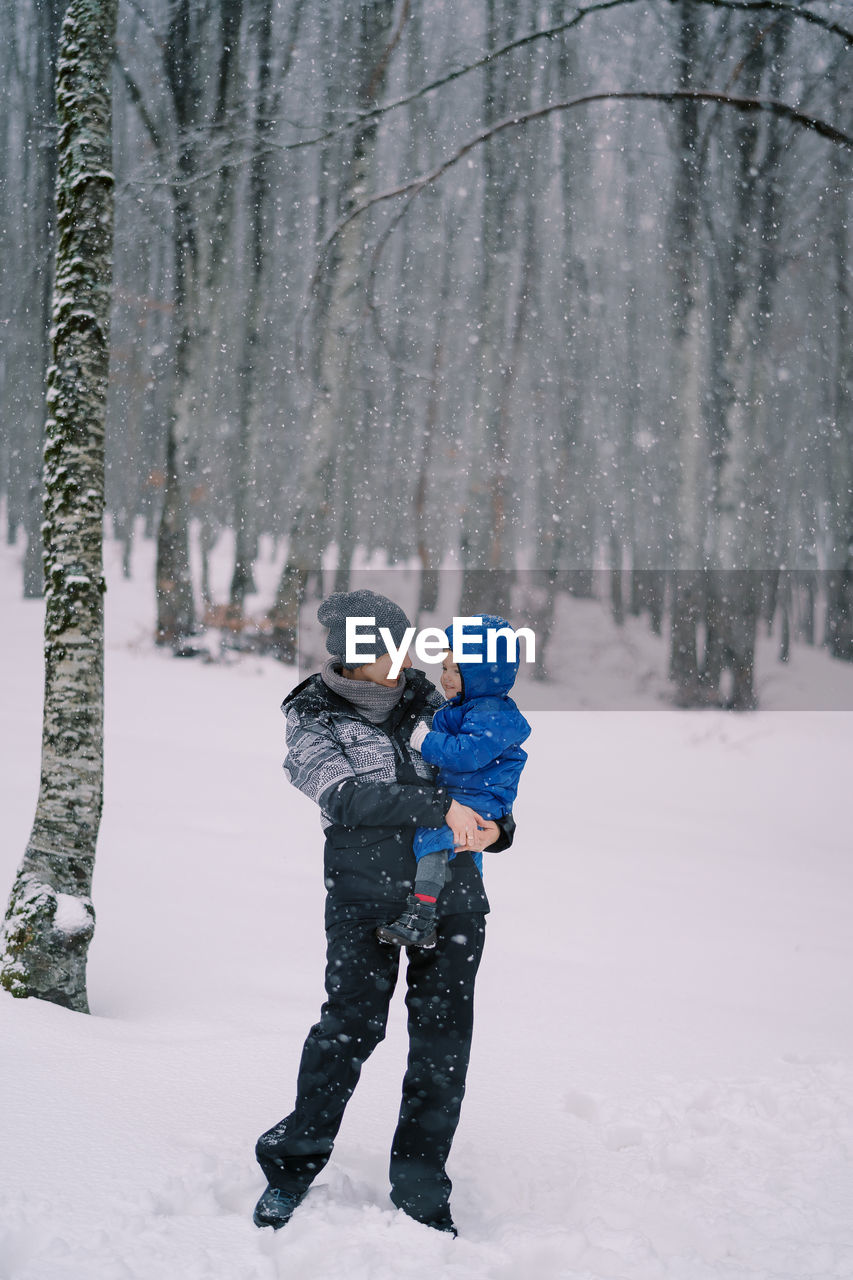 rear view of man standing on snow