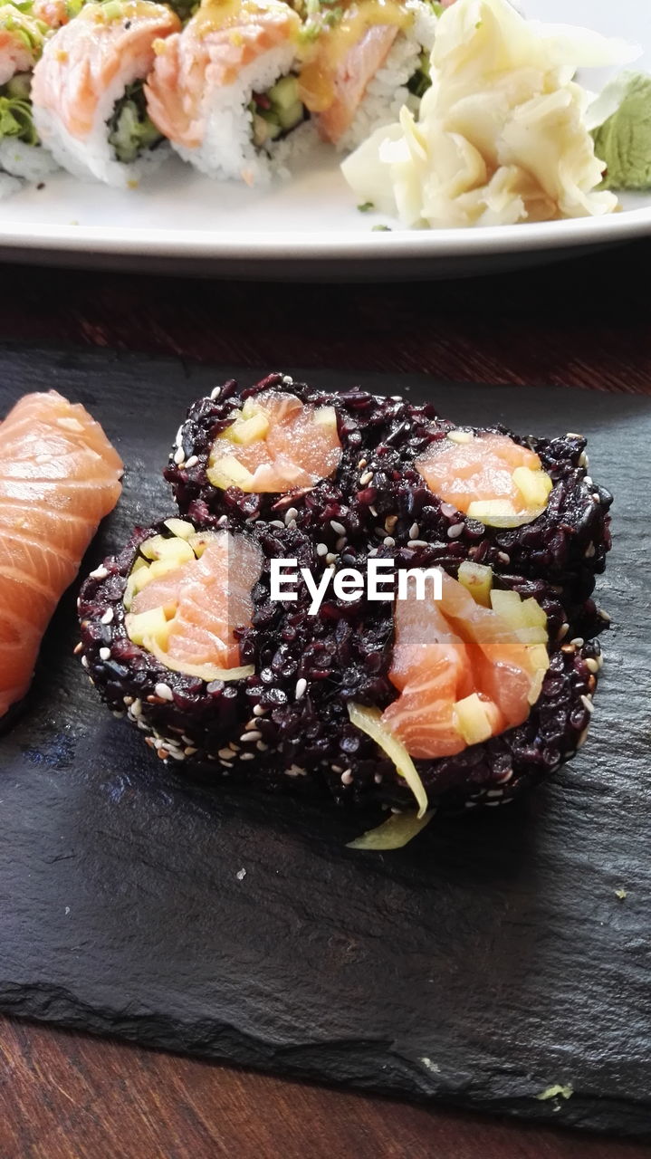 High angle view of black rice sushi on table