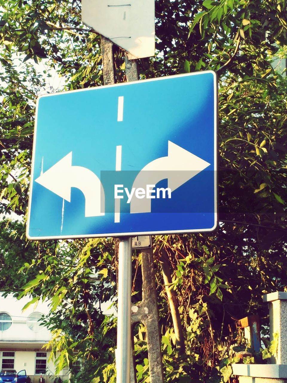 CLOSE-UP OF ROAD SIGNS AGAINST SKY