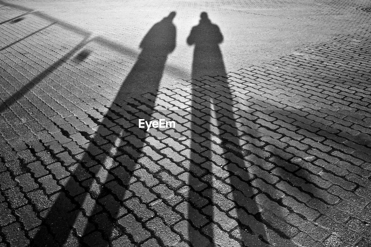 Shadow of two people on the road