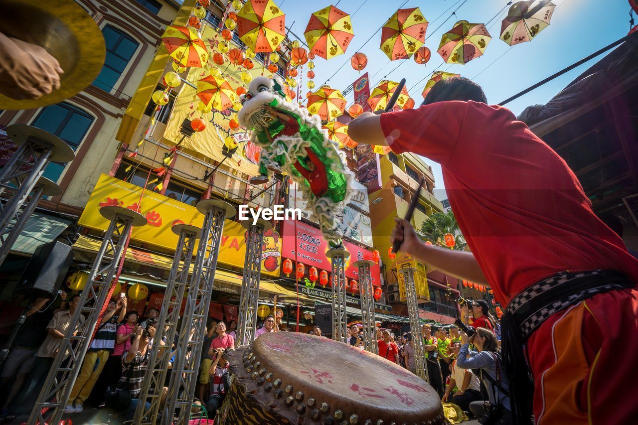 Low angle view of people enjoying lion dancing during chinese new year