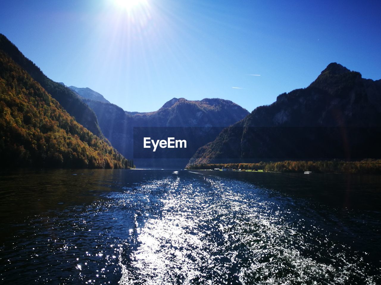 Scenic view of lake and mountains against sky