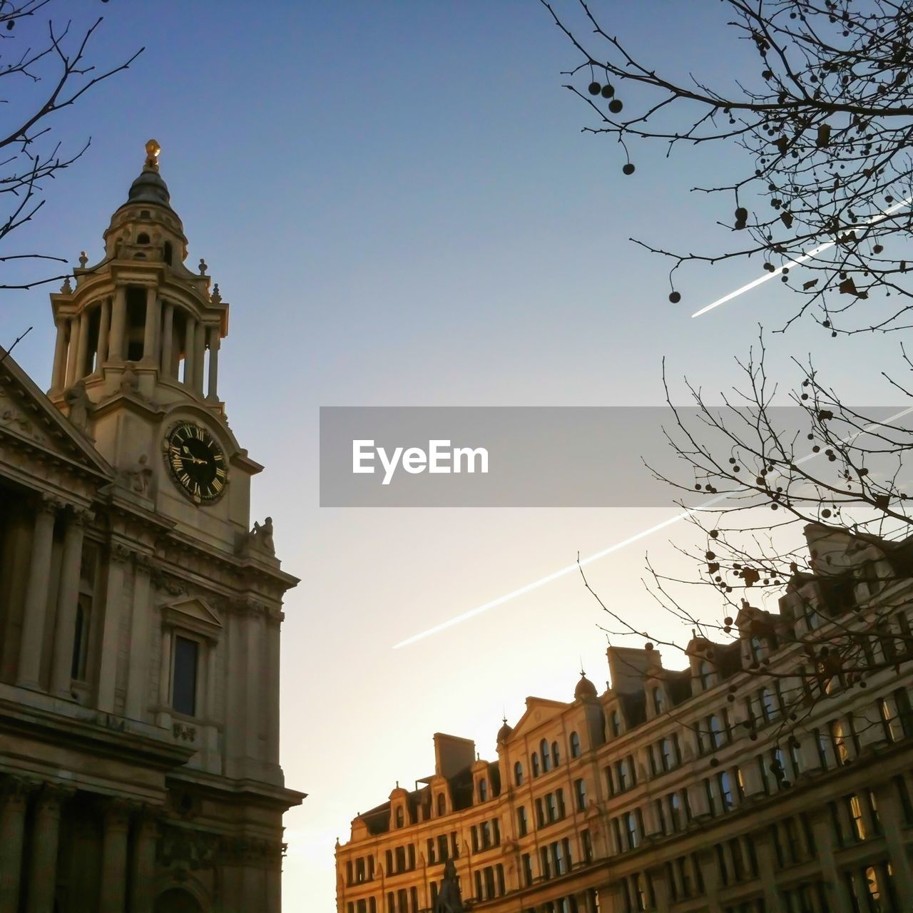 Low angle view of clock tower against clear sky