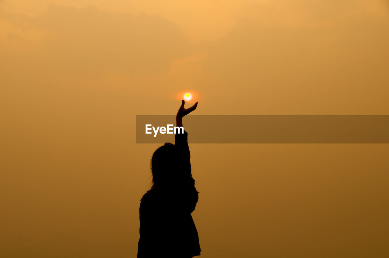 Silhouette of people at sunset