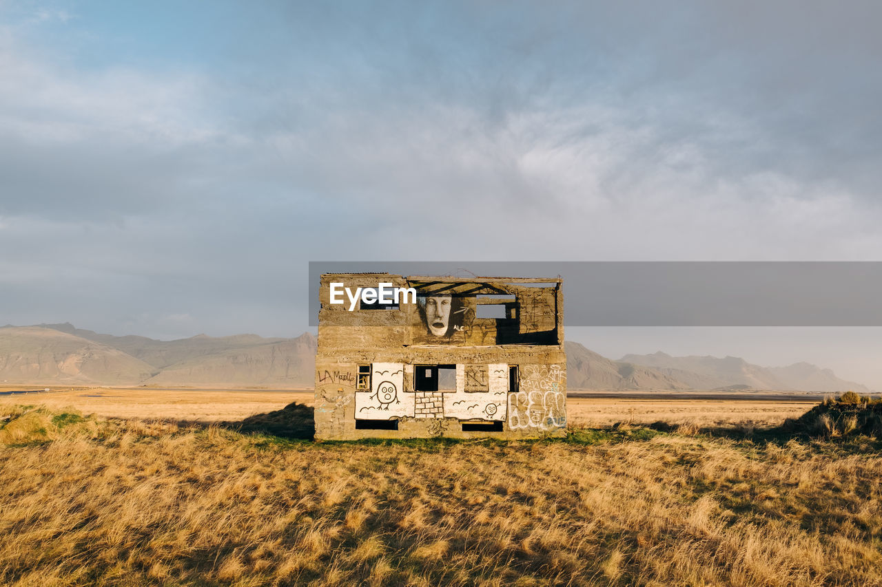 ABANDONED HOUSE ON FIELD