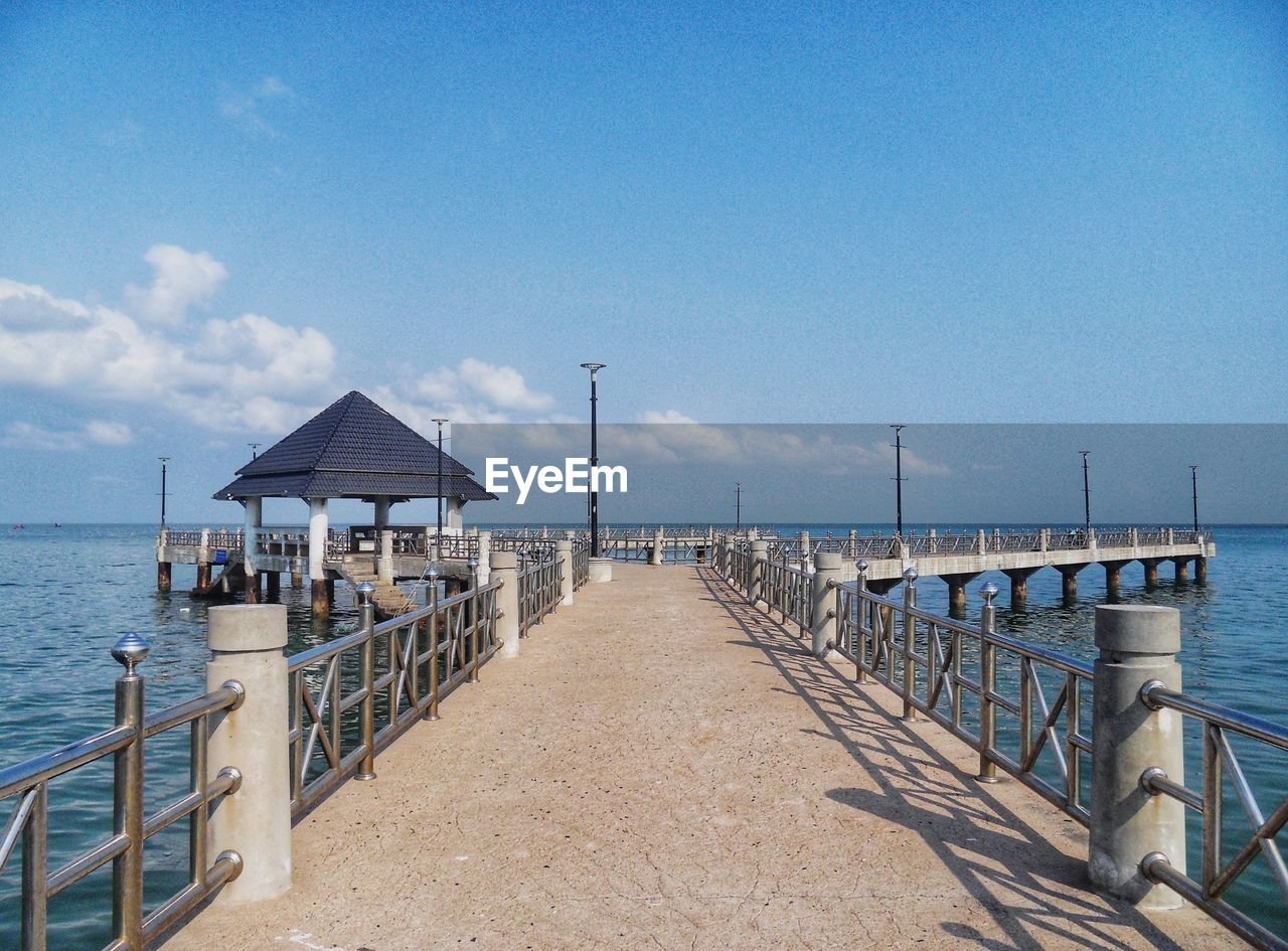 Pier over sea against sky